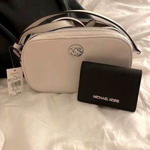 Mini MK white crossbody with black wallet.